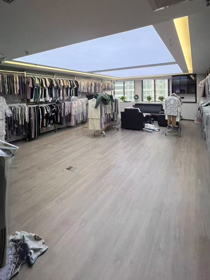 Sample room with rails of covered garment samples