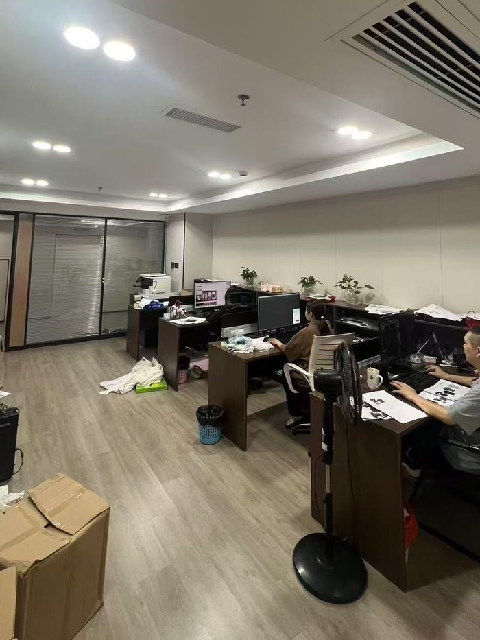 Merchandising office with staff working on orders